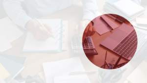 Professional calculating figures for UAE corporate tax with a laptop and documents on the table.